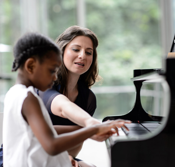 woman at piano with student